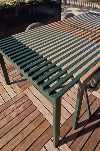 A wooden bench with slats in green and brown.